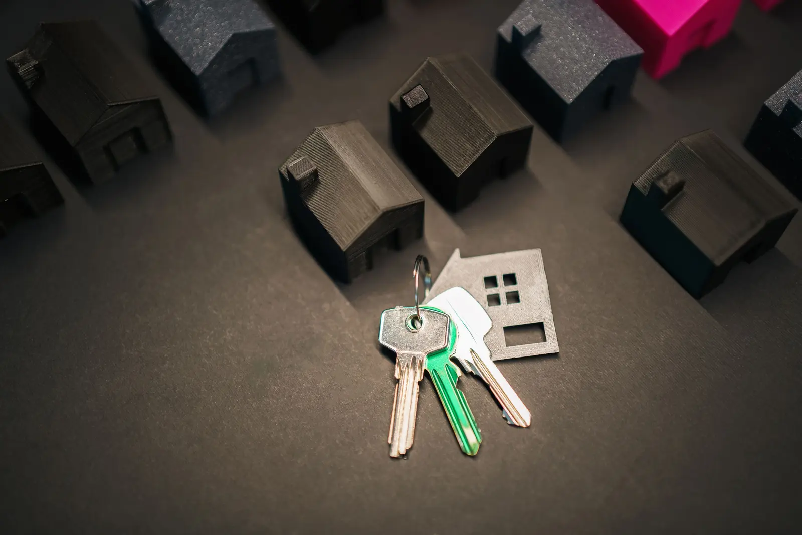 House keys resting among small model houses